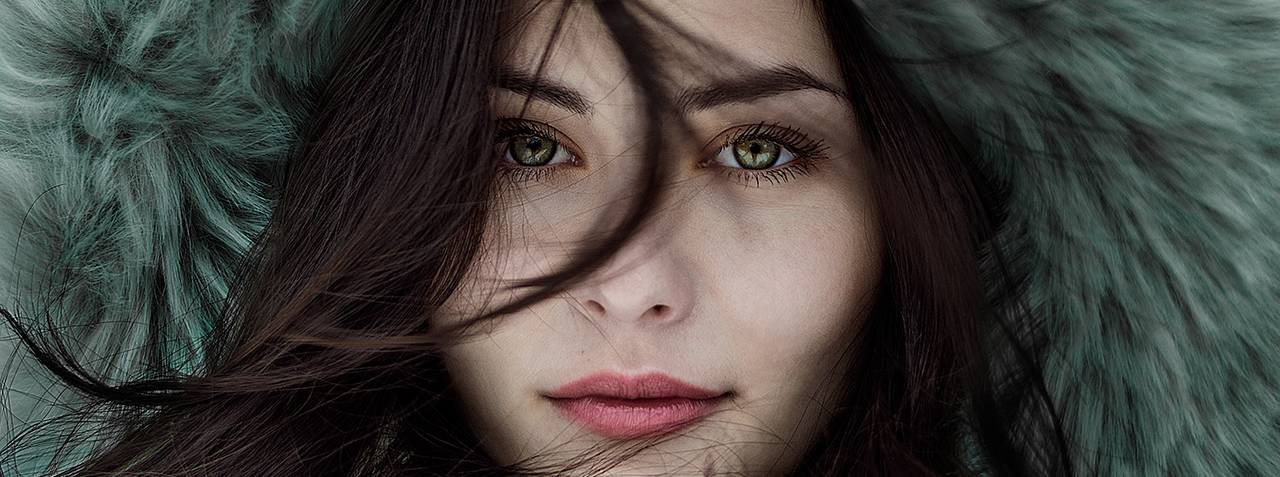 woman furry hat green eyes